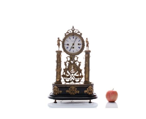 A BRASS TABLE CLOCK WITH A QUARTER STRIKE AND A SLOT MACHINE | CARL BALZAREK IN MÜGLITZ (CZECH / BOHEMIAN 2ND THIRD OF THE 19