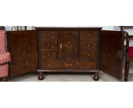 An 18th century Dutch mahogany and marquetry small side cupboard, inlaid with urns of flowers within chequer banded borders, 