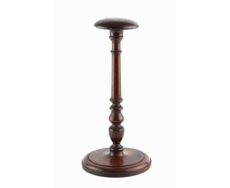 A mahogany wig stand, the rounded top on baluster and ring turned column, and circular base, 29cm high.
