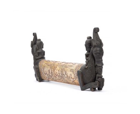 Tribal interest, Indonesian Sumatra, Batak, medicine container, carved elephant bone and carved wooden figures to ends, 50cm 