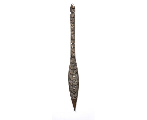 An Oceanic Maori ceremonial club, carved wood with mother of pearl inlay 66cm long Provenance: From the collection of the lat