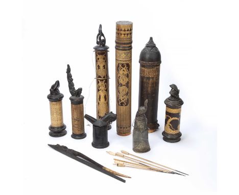 A collection of Indonesian carved wood and bamboo lime powder containers for betel nuts, together with a buffalo horn contain