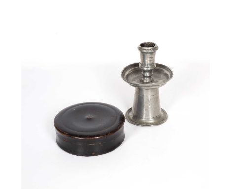 An English late 16th or early 17th century pewter candlestick, on a cicular base with integral drip pan beneath ring turned, 