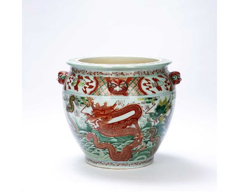 A large 20th century Chinese ceramic fish bowl, decorated with painted red and green dragons, 35cm high