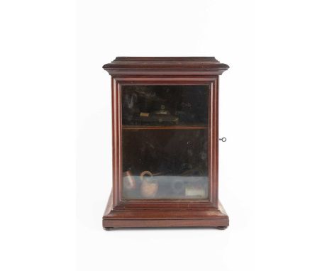 A Victorian mahogany smoker's cabinet, with glazed door, containing a collection of briar pipes, pipe cases etc, 27.5cm wide.