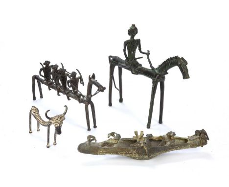 A group of four cast metal sculptures of the Dhokra Damar, West Bengal, including a man on horseback, a cow and warriors on h