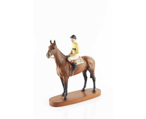 A Beswick figure of the racehorse Arkle, with jockey Pat Taaffe up, on oval wooden plinth base, 32.5cm high.Condition report: