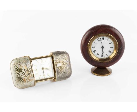 A French Art Deco rouge onyx circular desk timepiece, with enamel dial, on gilt oval foot, 10cm wide, together with a 1950's 