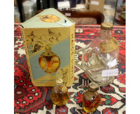 A boxed Haig's Dimple Scotch Whisky dating from 1952, with two similar miniature bottles and an empty Dimple bottle (4) 