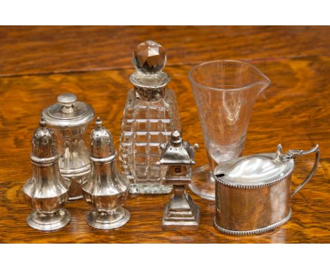 A collection of silver tableware, comprising a pair of pepperettes, a mustard pot with glass liner, a pepper grinder, a furth