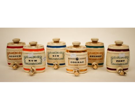 A set of six Wade barrel decanters, comprising part Port, Rum, Cognac, Scotch, Sherry, Gin. (6)