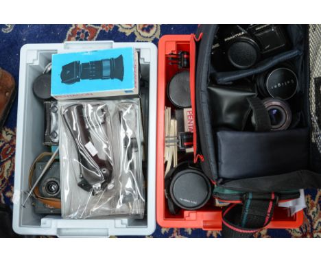 A collection of vintage cameras and lenses including Praktica and Carl Zeiss Jena Sonnar f2.8-f32, 180mm lens and accessories