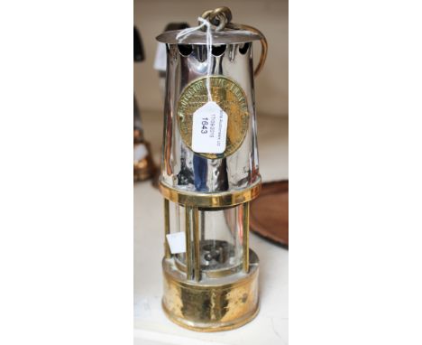 A Victorian miner's lamp, labelled 'Eccles, Manchester', No 67.