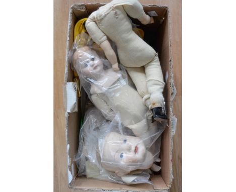 a collection of contemporary porcelain dolls head, limbs, bodies with sewing patterns for soft bodies, etc, all vintage style