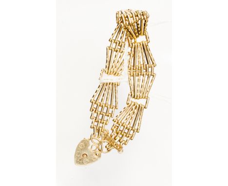 A 9 ct yellow gold gate bracelet of six bar lozenge shape links, padlock clasp, approximately 14.4 grams.