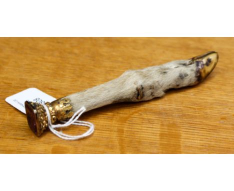 A yellow metal mounted deer hoof, circa 1840, the end with an intaglio engraved amethyst seal with crest, the 'shoe' end with