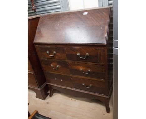 A Georgian style mahogany bureau, the fall front over three long graduated drawers, raised on bracket feet