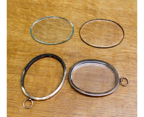 Two oval yellow metal glazed frames for portrait miniature, 75 mm long, ring to the top.