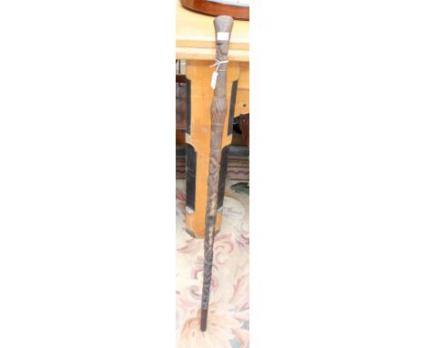 A late rosewood hand carved walking stick, probably African, depicting native figures, length 87 cm.