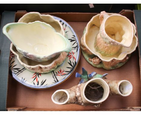A collection of six pieces of Sylvac, including a blue bird vase, a rabbit jug, two pant pot holders and a bamboo pattern bow