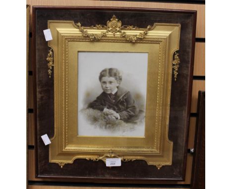 A framed ceramic sepier picture of a young boy - signed by artist.