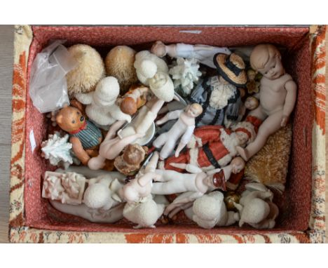 A collection of dolls house doll's, some in vintage style clothes, with some snow babies, in a 'carpet bag style' box.