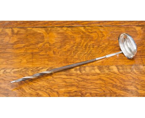 A late 18th Century white metal and whale bone handled punch ladle.