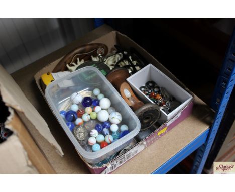A box containing marbles; horse brasses; various keys; egg timer etc