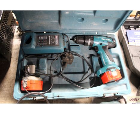 A Makita cordless drill and charger in case