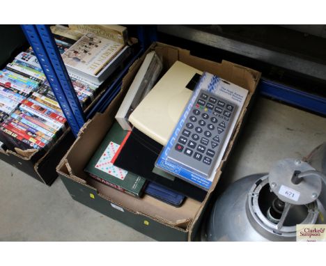 A box containing scales, games and a huge button universal remote control