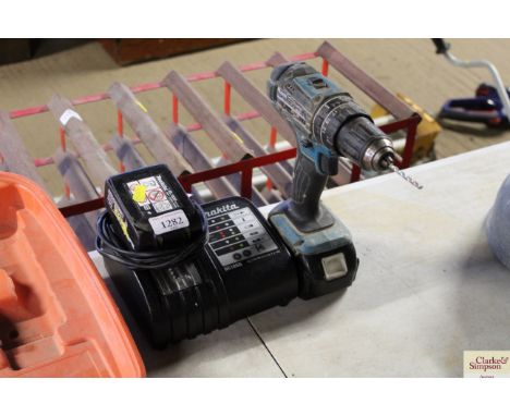 A Makita cordless drill with charger 