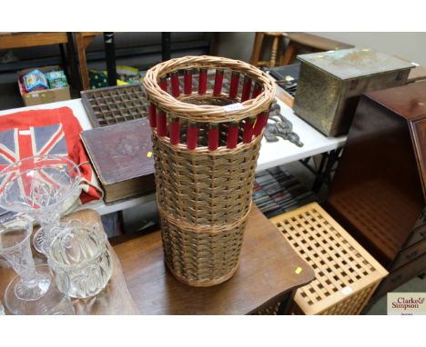 A wicker stick stand decorated with shotgun shells