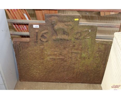A large cast iron vintage fire back with very worn motif and dated for 1622