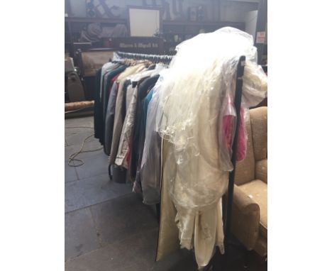 A RAIL OF MAINLY VINTAGE CLOTHING INCLUDING A WEDDING DRESS, MENS JACKETS ETC