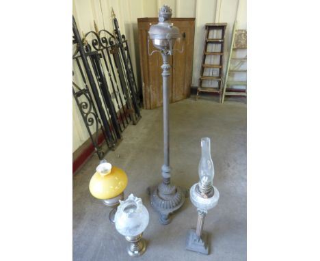 A Victorian brass standard oil lamp and three other oil lamps