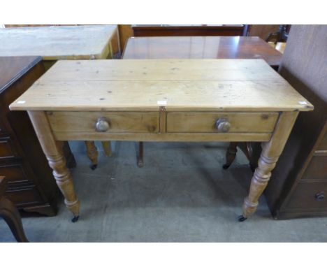 A Victorian pine two drawer side table