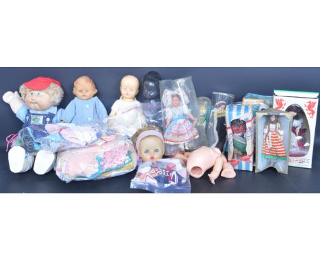 A large collection of vintage 20th century dolls and dolls clothing to include a Cabbage Patch Kids doll, a pair of unopened 