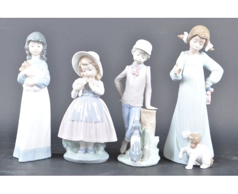 A collection of four contemporary Nao figures comprising of a girl with a dog (B70), boy with a dog, girl with a dog together