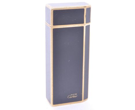 A vintage 1970s must de Cartier gold plated and black enamelled pocket lighter. The lighter of rectangular form with one cant