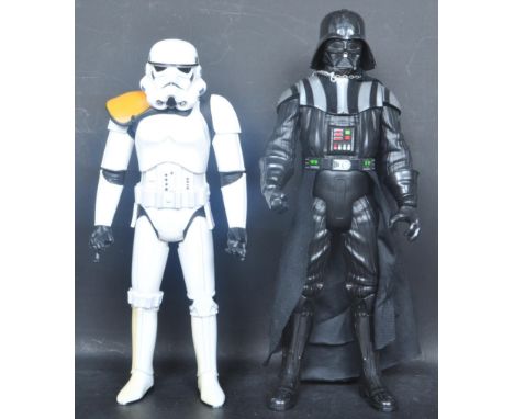 A pair of vintage 20th century plastic Star wars figures to include a Darth Vader toy and a Storm Trooper toy. Both having ar