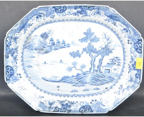 An 18th Century Chinese Oriental Blue and White charger meat platter having a central panel of a coastal scene with a border 