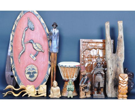 A collection of African - tribal wares to include large wicker tapering basket, wooden carving, relief carved wooden panel, d