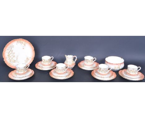 An early 20th century circa. 1900 twenty-one piece Limoge tea service comprising of six teacup and saucers trios, a cake plat