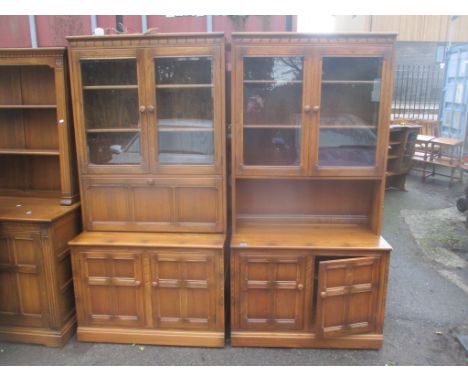 Two Ercol elm Golden Dawn display cabinets having shelves above drawers and cupboards, 196 h x 98cm w