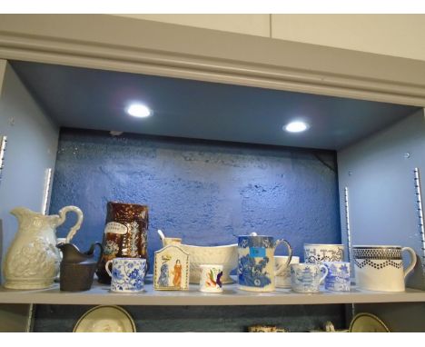 A selection of 19th century and later ceramics to include a Bargeware Drink and Be Merry jug, a tea caddy in Prattware colour