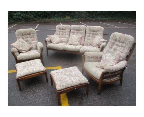 An Ercol Elm Golden Dawn three-seater sofa, together with two armchairs and two foot stools