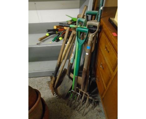 A selection of wooden handled garden tools together with modern garden tools and a metal hose stand