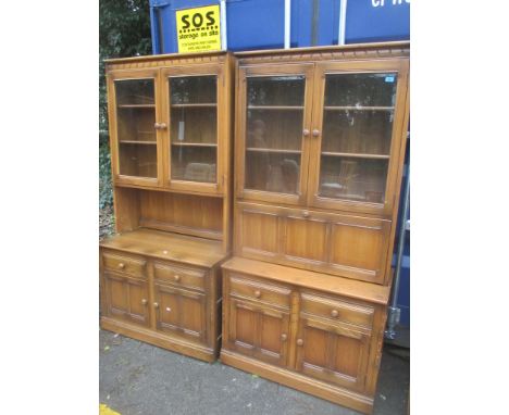 Two Ercol elm Golden Dawn display cabinets having shelves above drawers and cupboards, 196 h x 98cm w