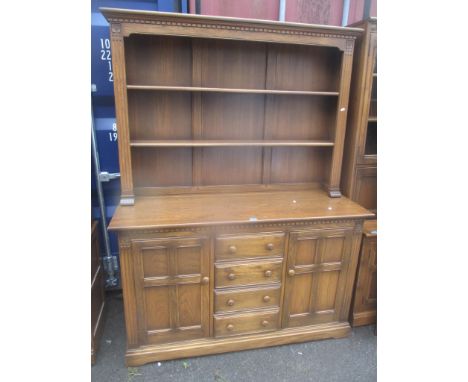 An Ercol elm Golden Dawn dresser plate rack above cupboards and drawers, on a plinth base, 198 h x 144.5cm w