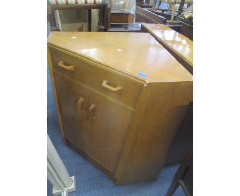 A G-plan E Gomme light oak corner unit together with a light oak bookcase and a two door cabinet 